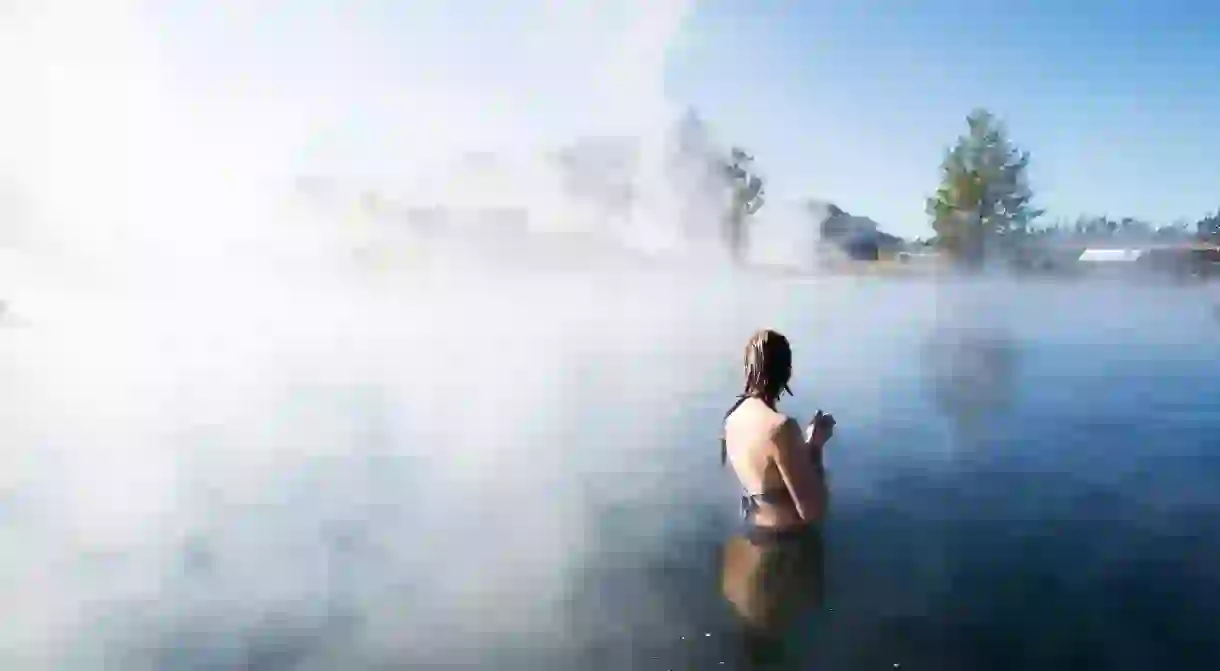 KRY4RY A woman bathing in The Secret Lagoon in Iceland