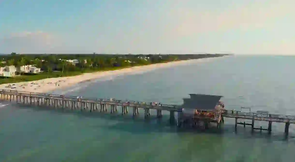 Lay down a rod at Naples Pier, a popular fishing spot, before relaxing on the neighboring sands