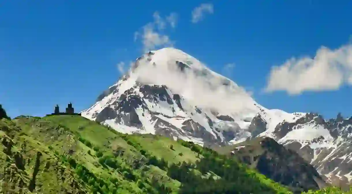 The Gergeti Trinity Church sits on the slopes of the majestic Mount Kazbegi in Georgia