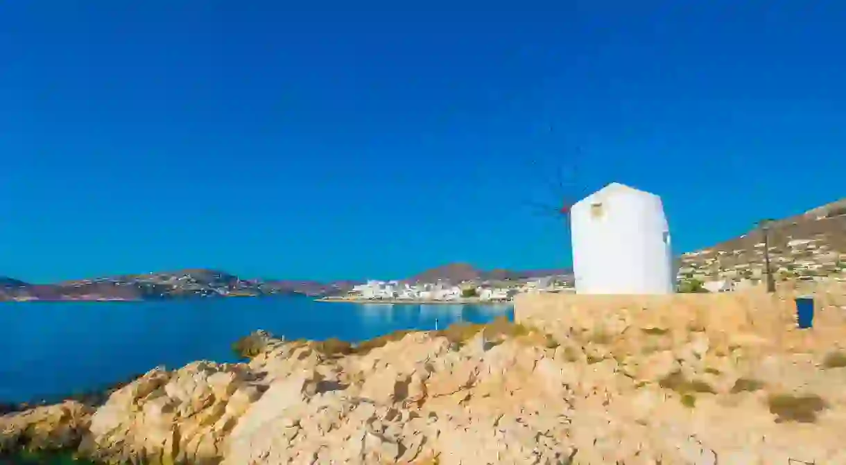 Old white windmills by the water on Paros, Greece, make for a beautiful photo opportunity