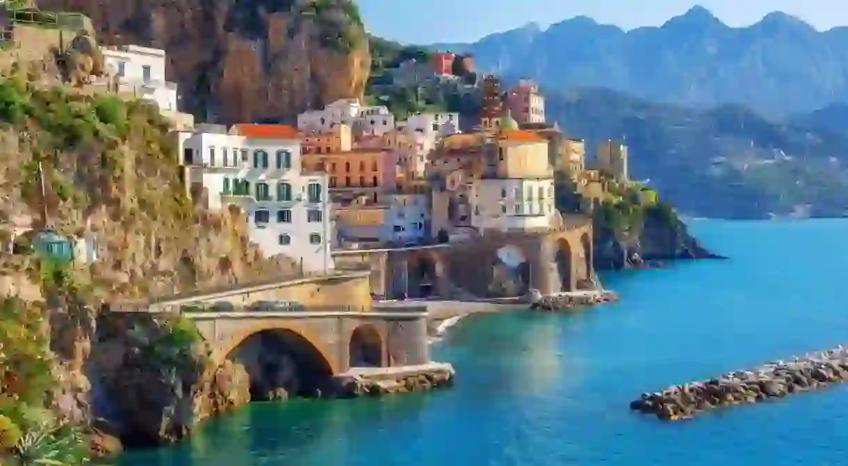 Visit the Amalfi Coast to experience the sparkling waters and picturesque villages for yourself