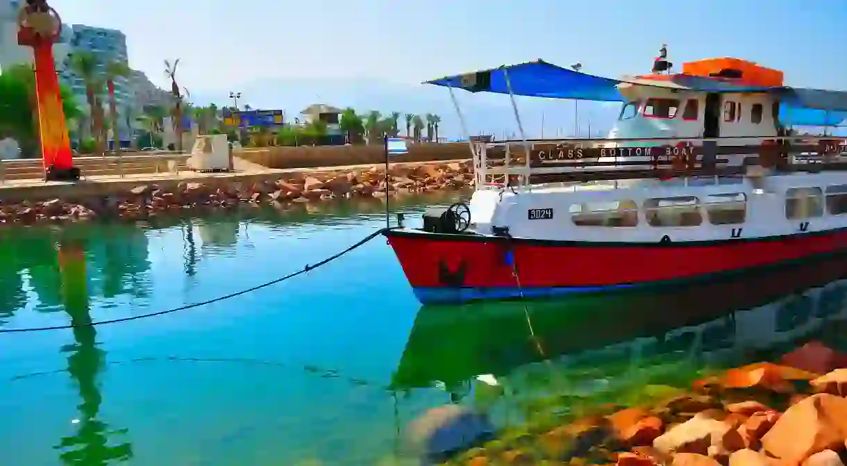 When visiting Eilat, take a glass-bottom boat tour to explore the Red Sea