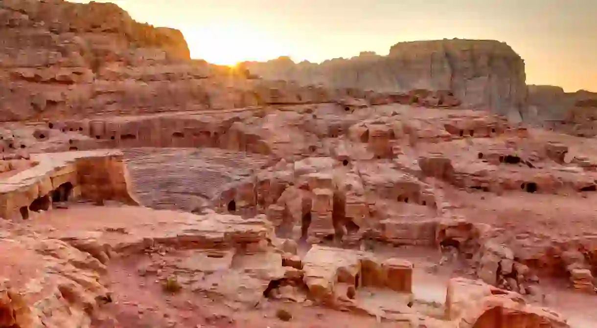 Watch the sunset over the tombs and amphitheatre in Petra, Jordan