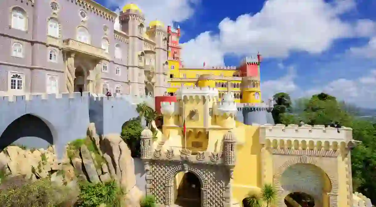 Sintras iconic Pena Palace is a wedding cake-like vision perched atop a rocky outcrop