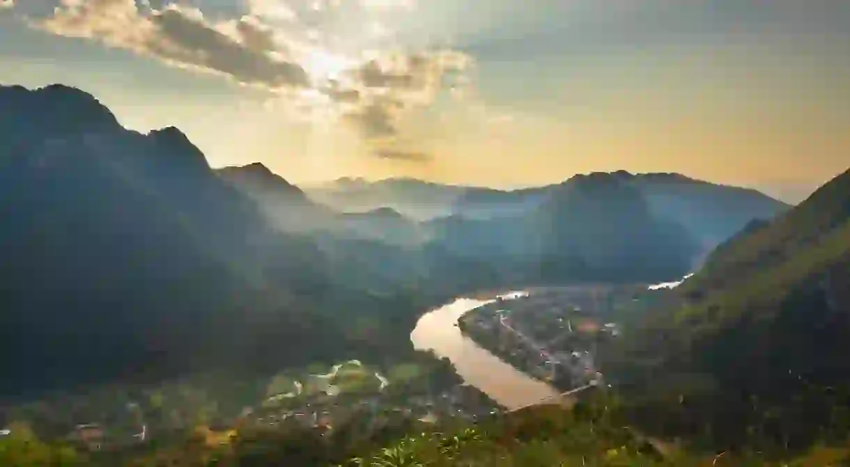 The Nam Ou, a tributary of the Mekong River, winds its way through the verdant Luang Prabang Province