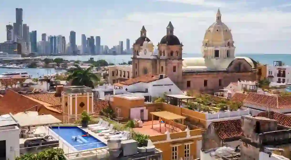 A church and its monastery on the Plaza de San Pedro Claver in Cartagena with the modern city in the background