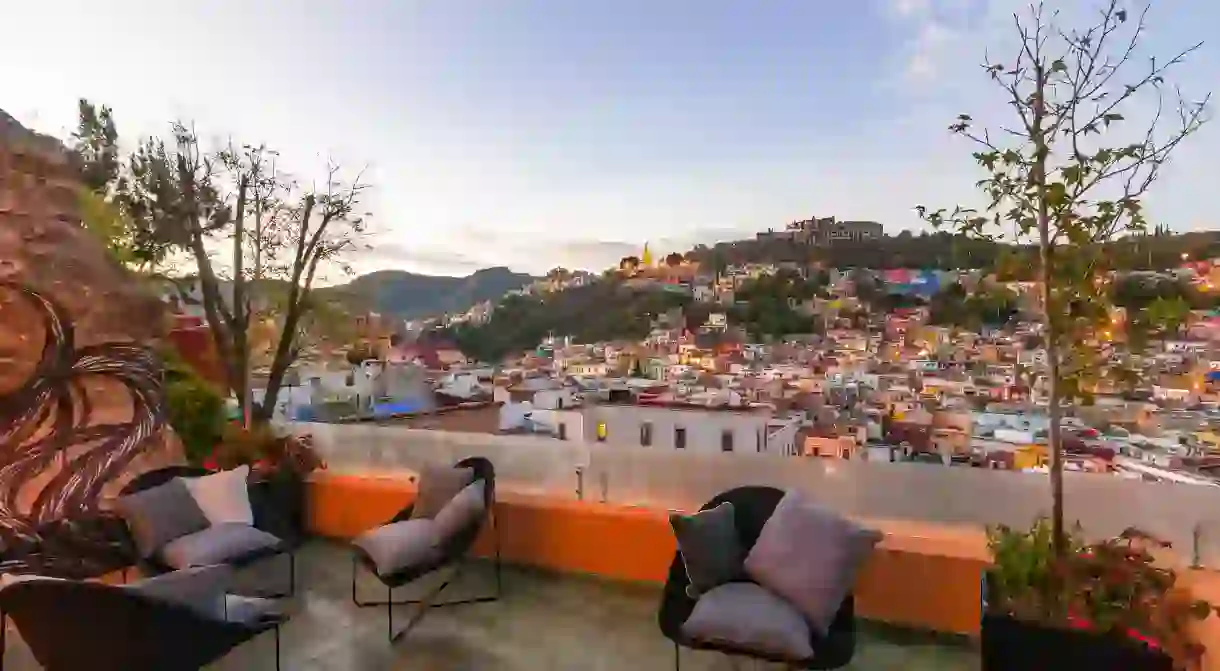 With a drink in hand, take in the beautiful views from the top of Casa del Rector Hotel Boutique