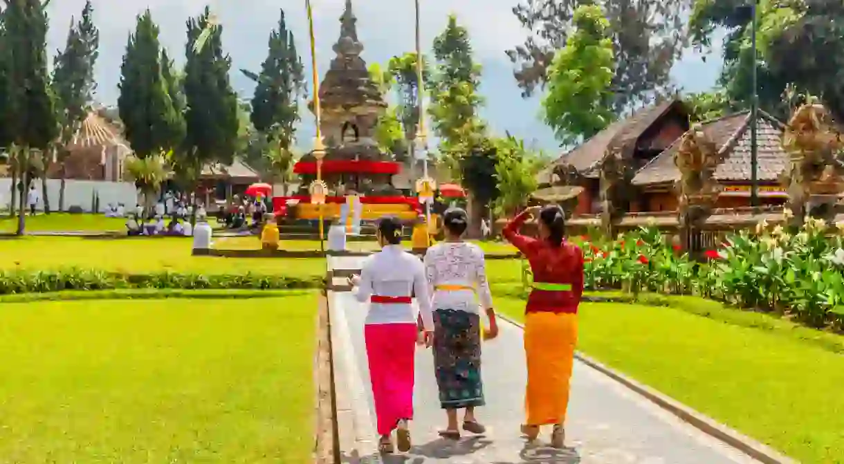 When visiting temples such as Pura Ulun Danu Beratan in Bali, make sure to dress appropriately