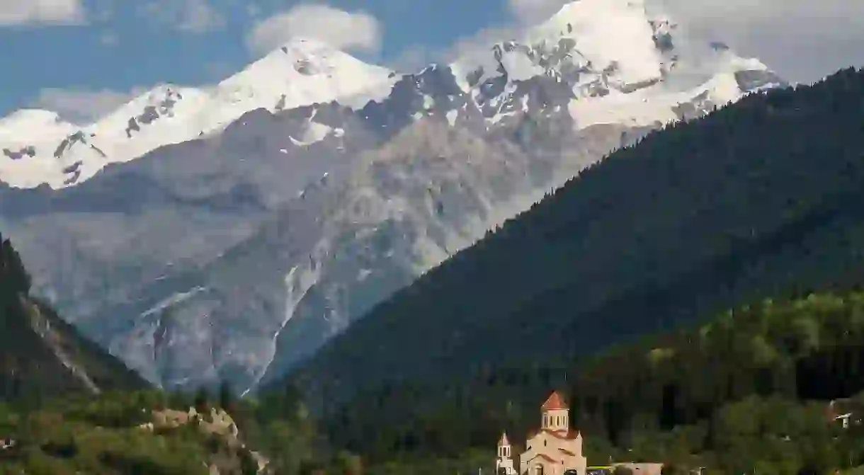 A church in Mestia, Georgia, with the Caucasus Mountains in the background