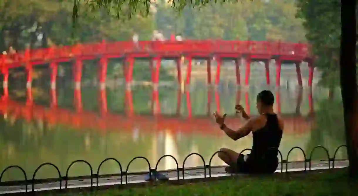 The pretty scarlet bridge at Hoan Kiem Lake makes for a beautiful backdrop for a photo