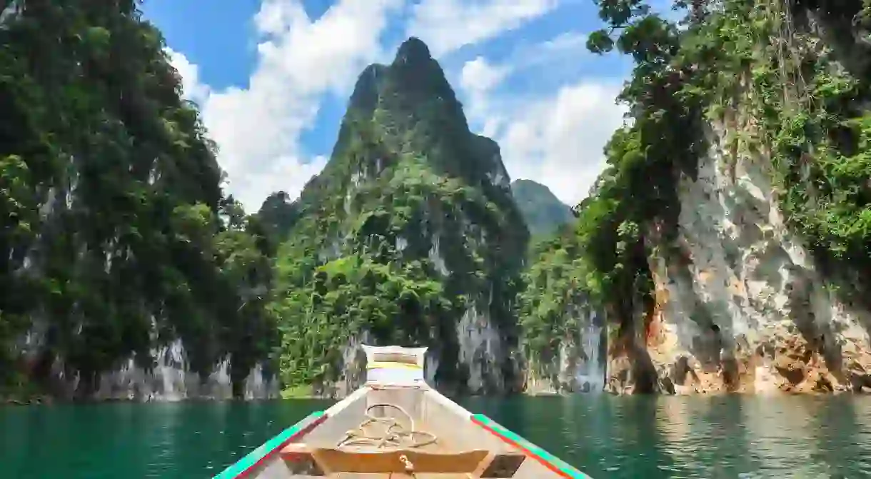 Hire a riverboat and cruise through one of the worlds oldest evergreen rainforests in the heart of the Khao Sok National Park