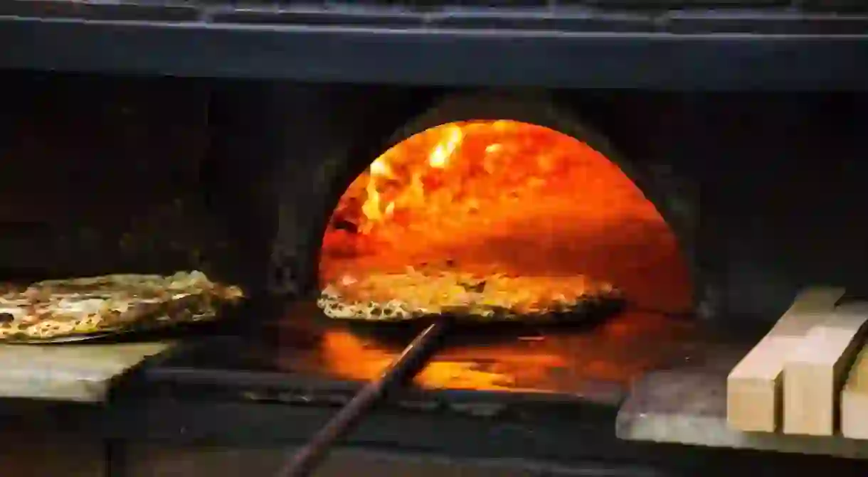 Pizza coming out of the wood-fired oven at the famous LAntica Pizzeria Da Michele in Naples