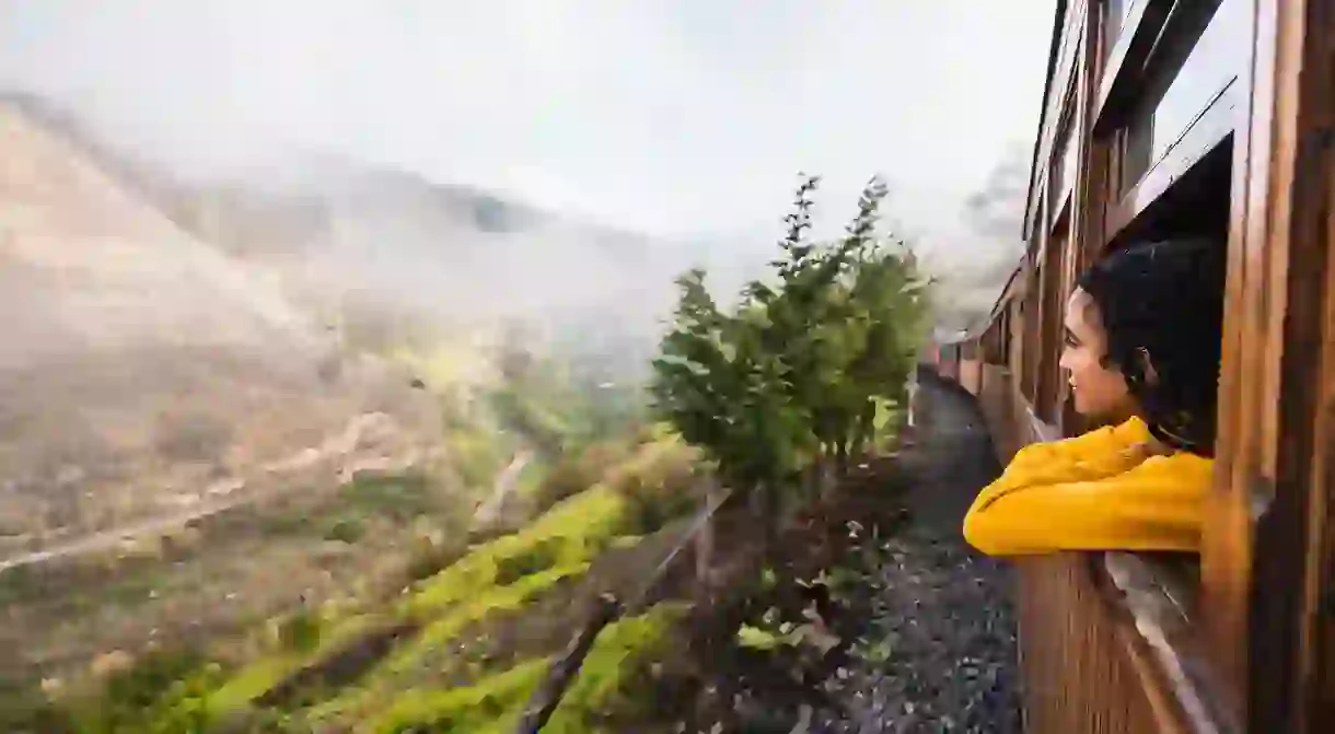 Girl looking out the window on the Devils Nose train from Alausi in Ecuador