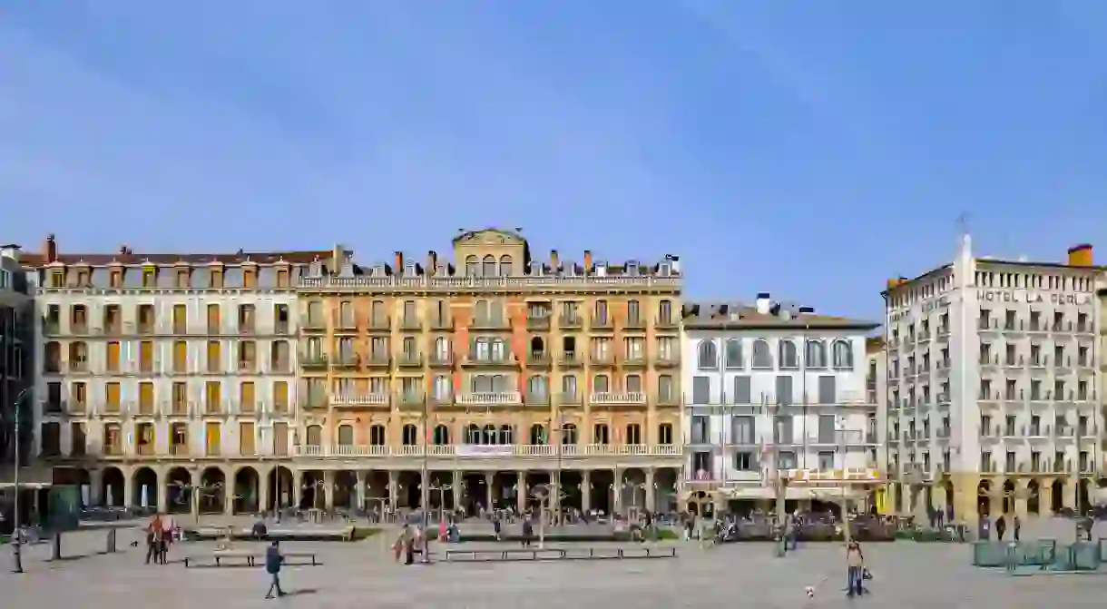 The orange facade of Café Iruña, made famous by Ernest Hemingway, dominates Pamplonas Plaza del Castillo