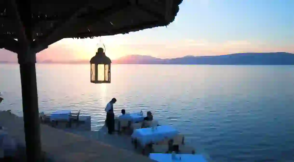 Catch a spectacular sunset overlooking Hydras harbour on a visit to Greece