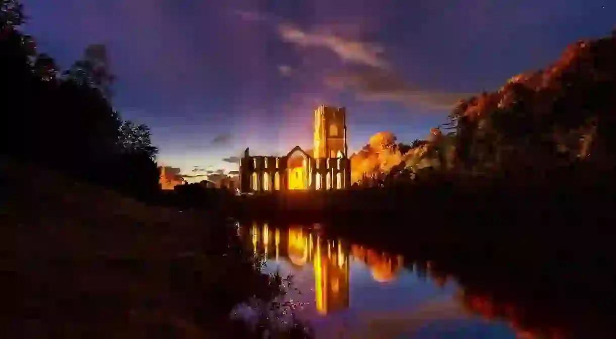 Fountains Abbey reflected in the waters of the surrounding gardens