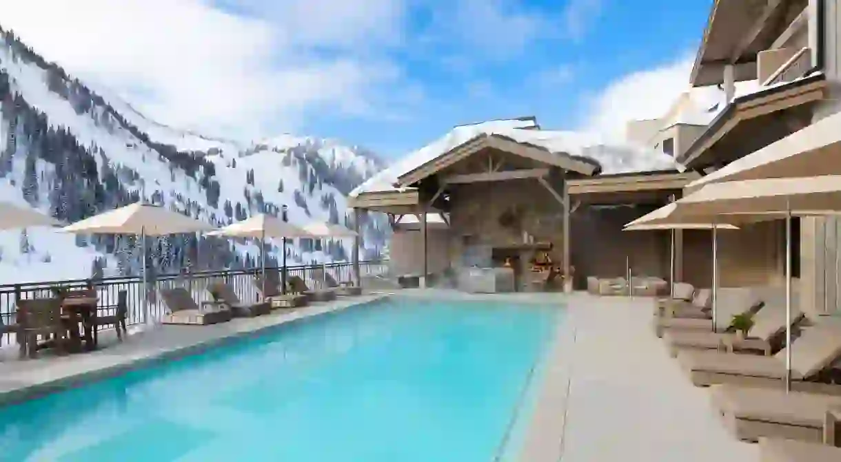 Gaze at snow-covered mountains from the pool at the Snowpine Lodge in Utah