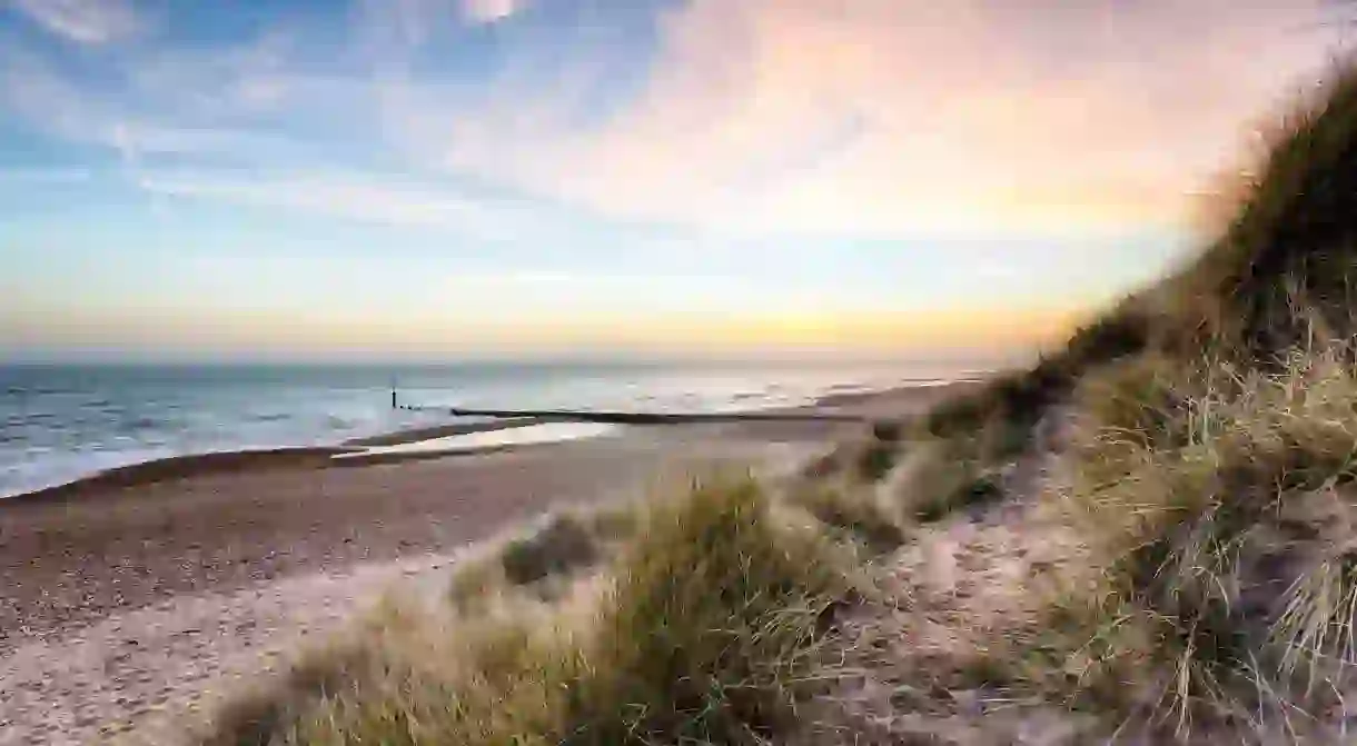 Enjoy a stunning sunset along the sand dunes at Hengistbury Head near Bournemouth