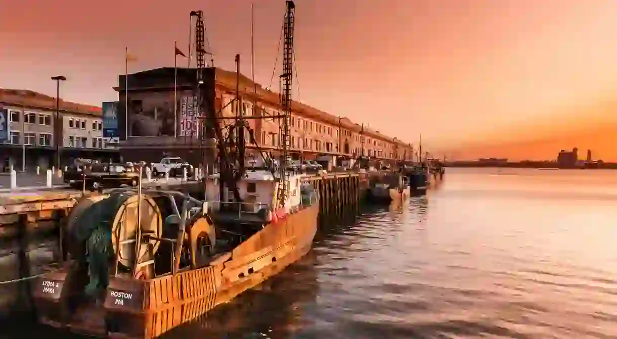 Watch the sunrise at the Fish Pier in the Seaport District in Boston