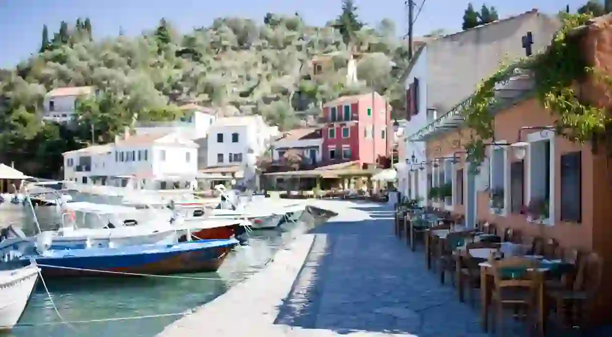 Look out over bobbing boats while you dine on Paxos, Greece