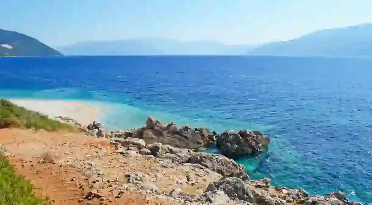 The multihued waters of Aspros Gialos Beach, free of boats and water sports, are ideal for swimmers