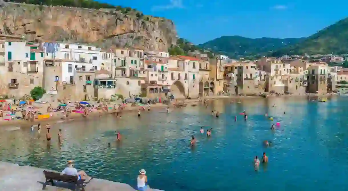 Find a sandy patch of shoreline in Cefalù and relax