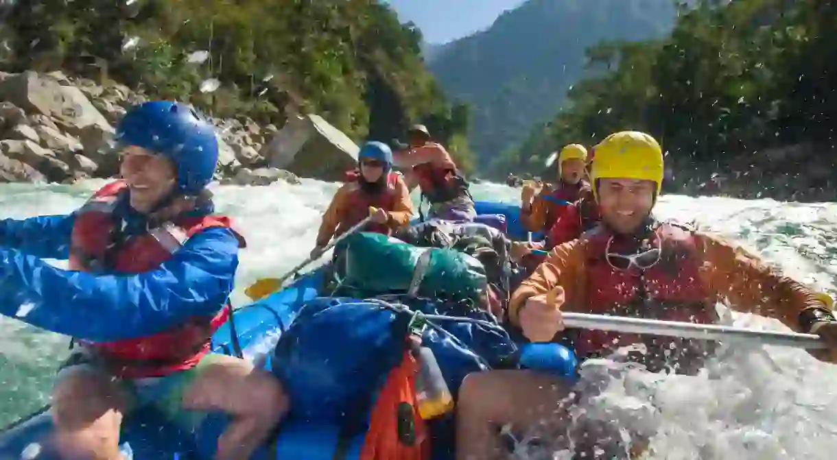 Rafters get splashed as they go through some big rapids on the Karnali River, west Nepal