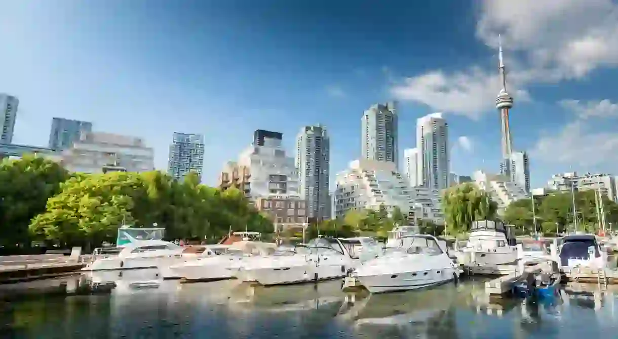 Downtown Toronto sparkles with high-rises and the CN Tower while boats bob in the water