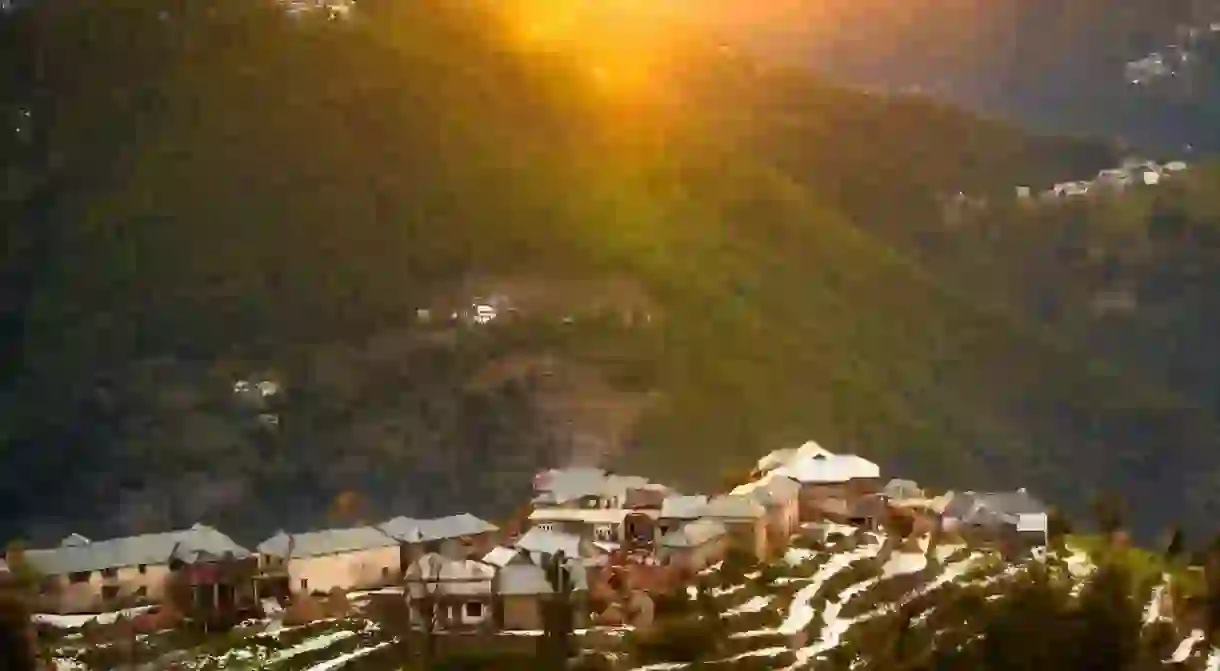 Aerial view of colourful mountain village houses in winter from a Khajjiar trekking route