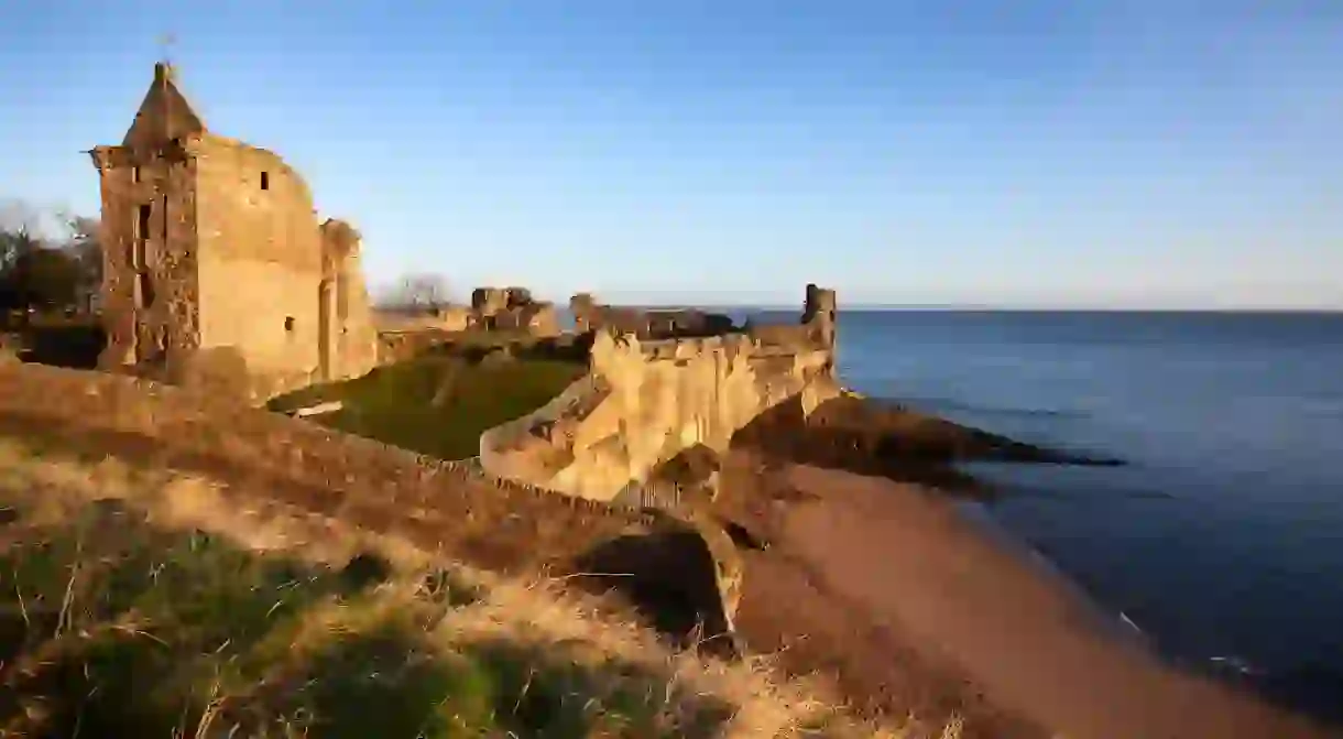 ENK13E St. Andrews Castle and Castle Sands from The Scores at sunrise, Fife, Scotland, United Kingdom, Europe