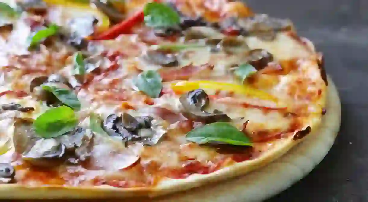 Traditional Italian pizza with mushrooms, peppers and pancetta