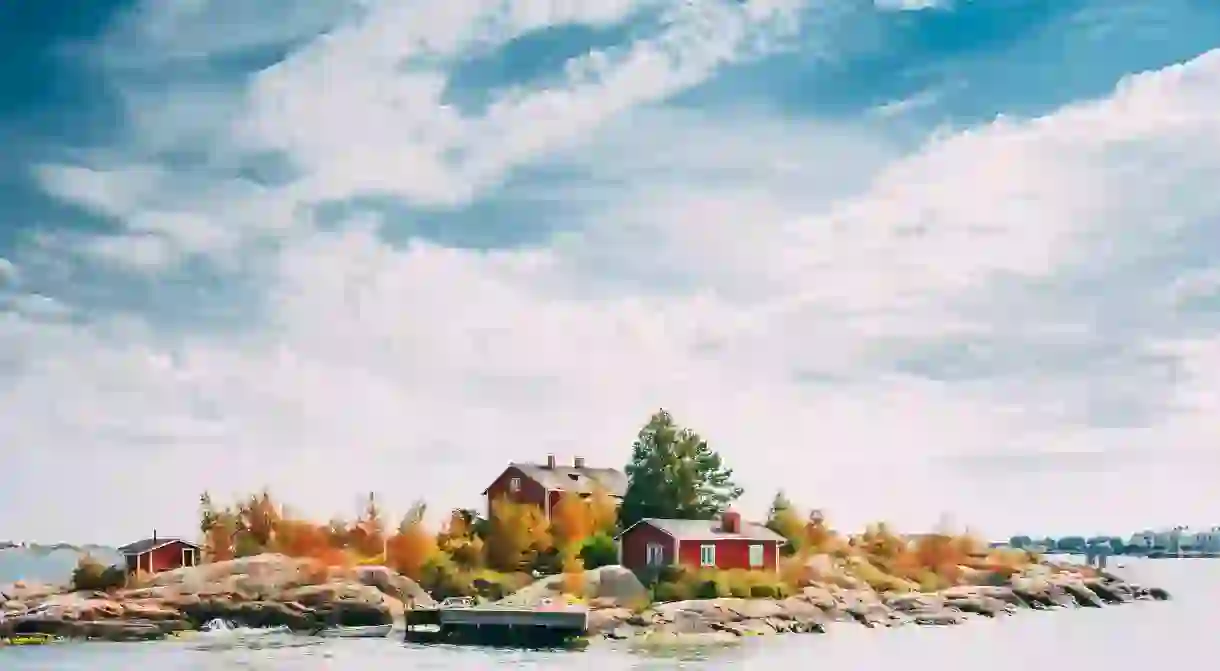 Beautiful Red Finnish Wooden Log Cabin House On Rocky Island Near Helsinki, Finland