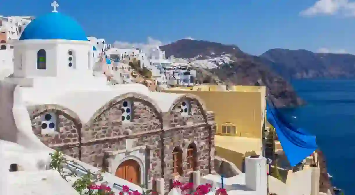 The church of St Nicholas with its iconic blue dome in Oia, Santorini