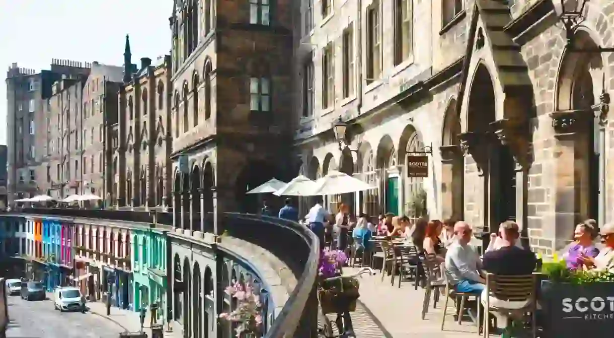 People eating along Edinburgh Old Town