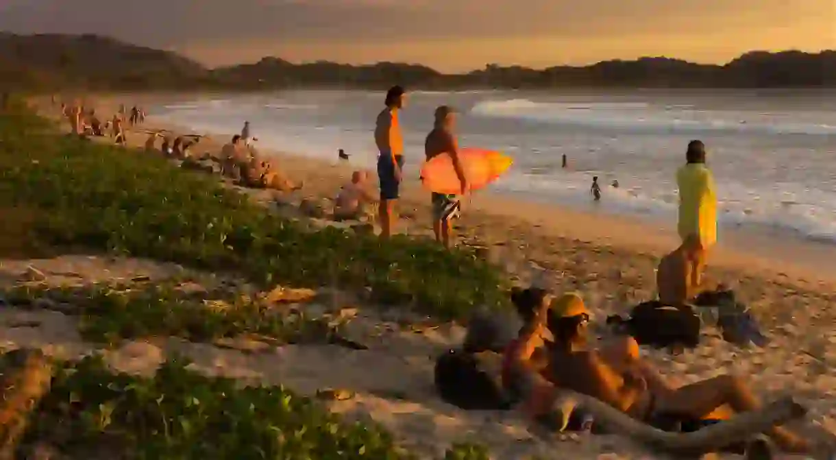 Experiencing a sunset gathering on Playa Guiones is a must for any surfer in Costa Rica