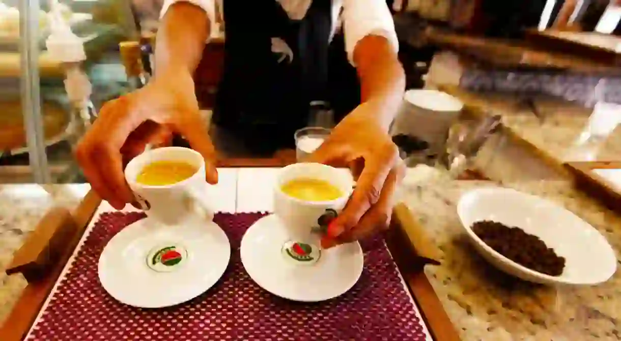 A waitress serves coffee to customers at a coffee bar in Sao Paulo