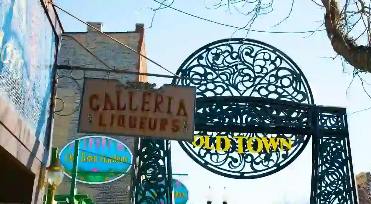 CHICAGO Illinois Old Town circular metal sign over sidewalk in neighborhood shop signs along street