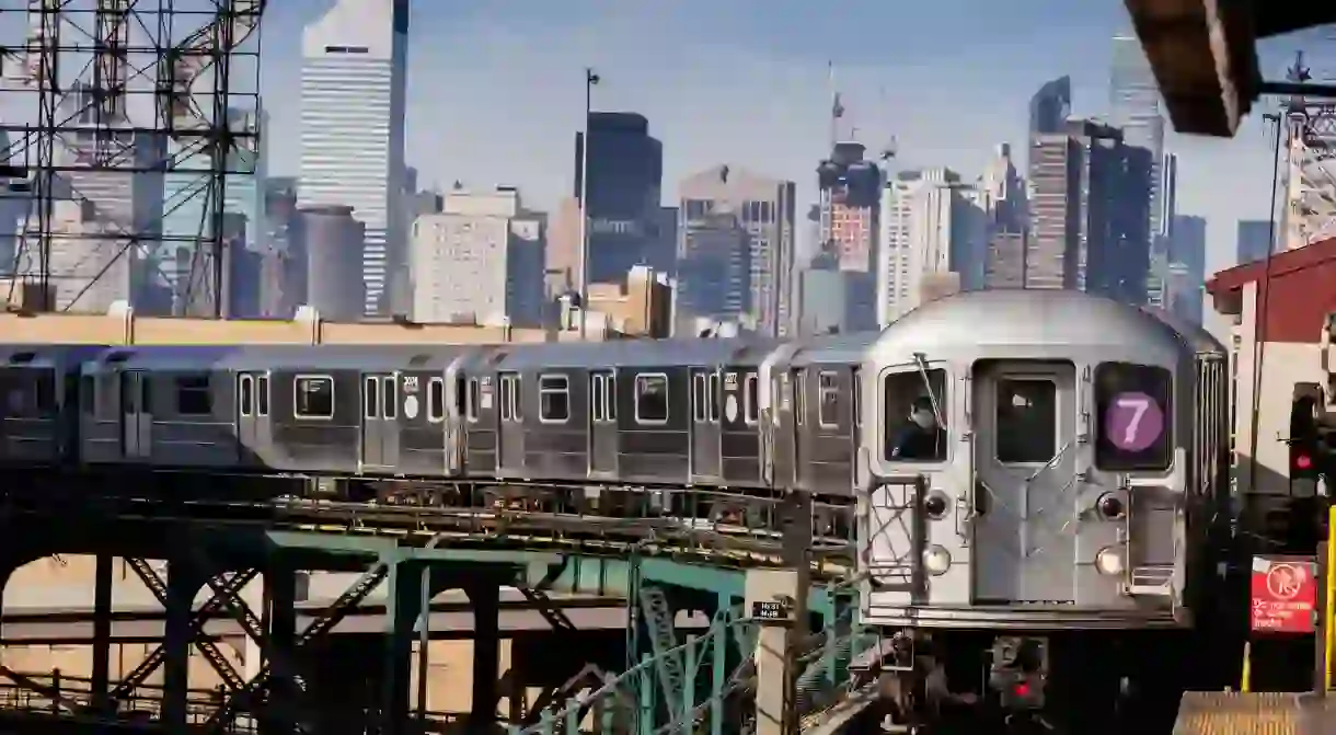 Flushing bound. The number 7 train arrives at a station in Queens, New York City