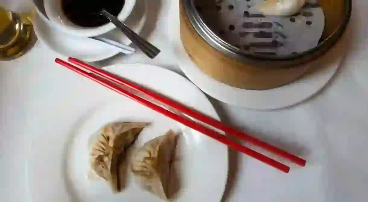 GN9F6R Steamed vegetable dumplings with soy sauce at a table in a Chinese restaurant in Chinatown in New York City