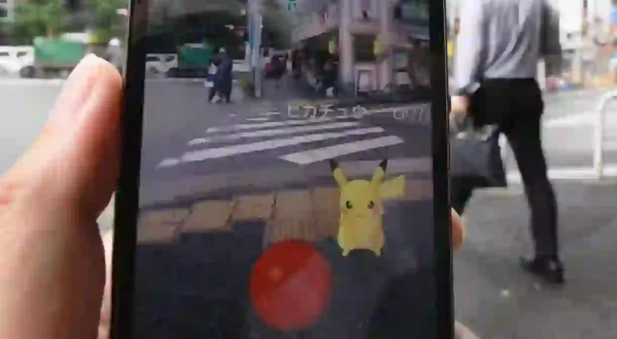 Pikachu appears on a mobile phone screen as a user plays the smash-hit Pokemon Go game in Tokyo