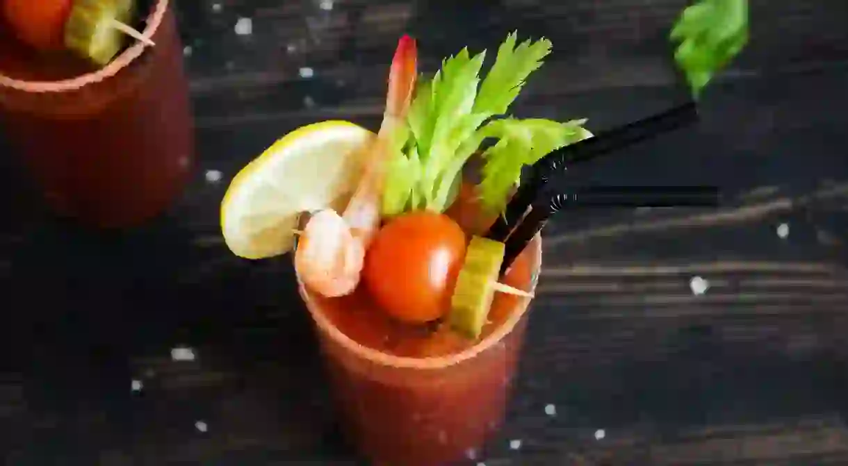 M9GPB0 Bloody Mary Cocktail in glass with garnishes. Tomato Bloody Mary spicy drink on black background with copy space. M9GPB0_