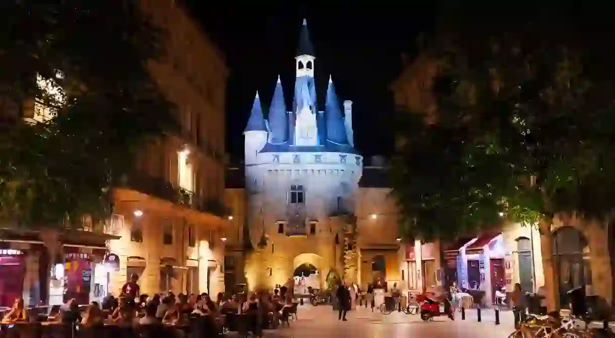 Port Cailhau Bordeaux France at night with busy restaurants in square