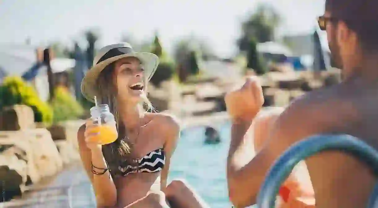 Young woman drinking cocktail and enjoying at the beach.