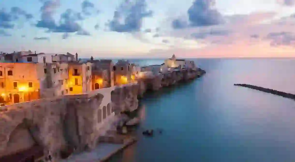 Soak up the sunset over the picturesque town of Vieste when you visit Puglia on a solo trip