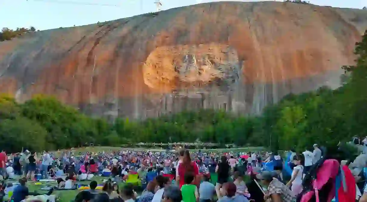 Crowd gathers beneath the Confederate Memorial Carving at Stone Mountain Park in Atlanta for the nightly Laser show