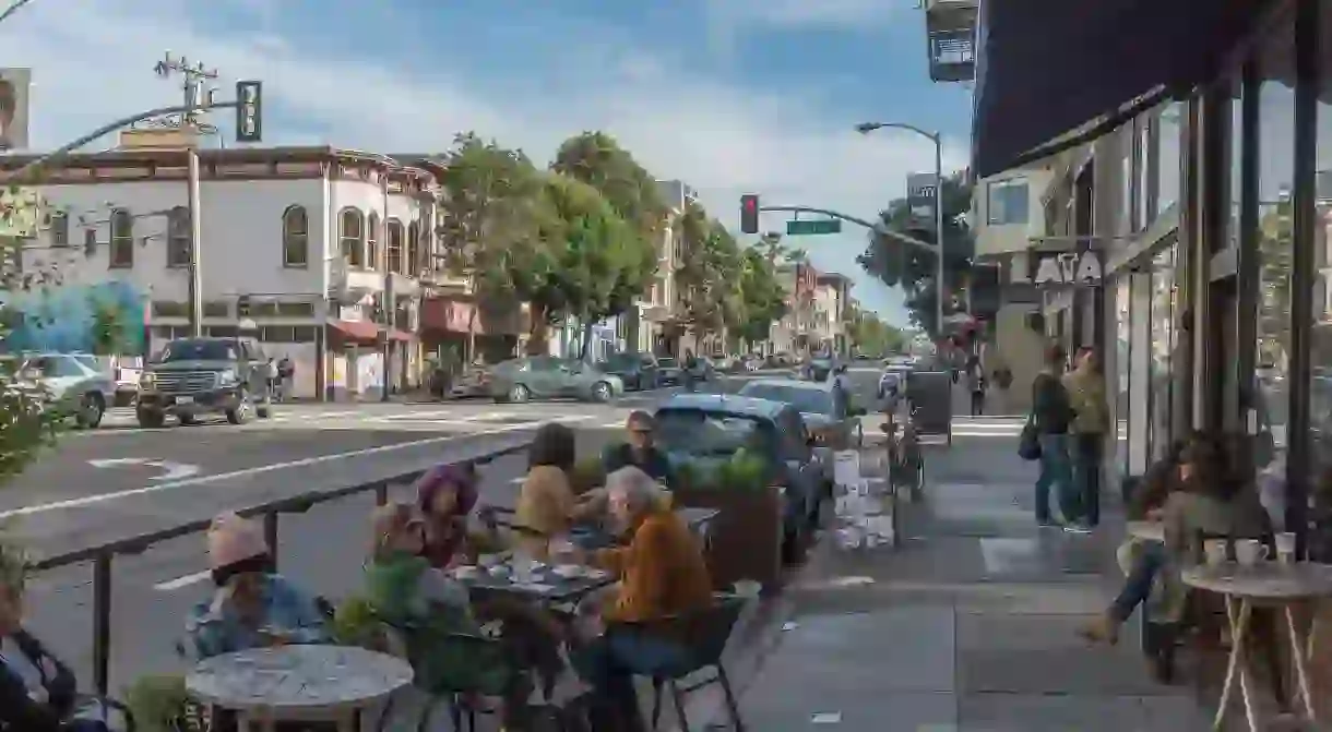 General street view on Valencia Street near the junction of 21st Street in the Mission District, San Francisco, CA, USA.