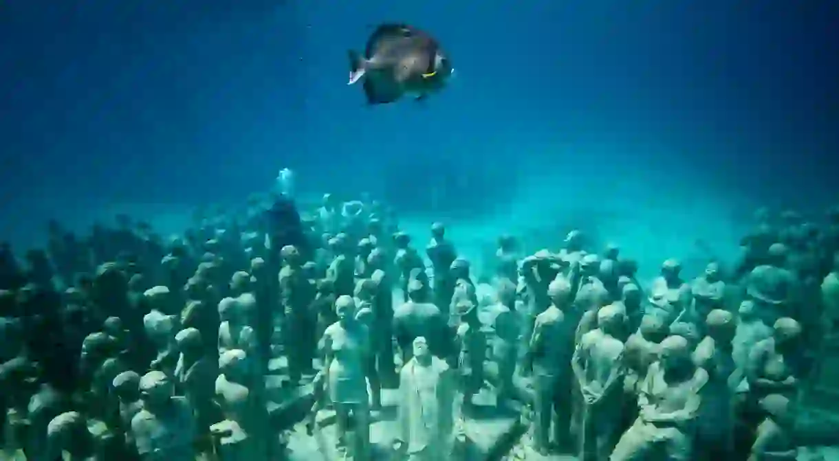 Stumble upon the underwater army of life-size human figures in Cancún, sculpted by the incredibly talented Jason deCaires Taylor