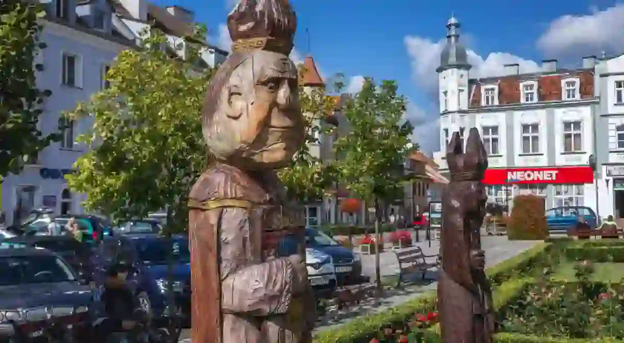 Wooden sculpture on a market square of Biskupiec city in Olsztyn County, Warmian-Masurian Voivodeship of Poland