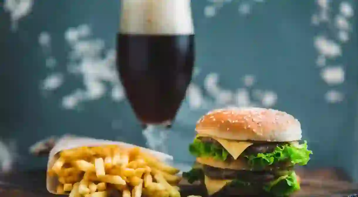 W9KHTX Burger with potatoes and dark beer on a wooden Board on a blue-gray background