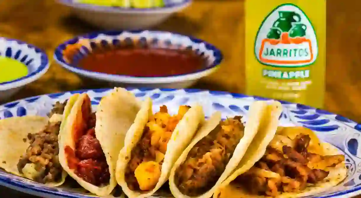 A mixed taco plate served with an all-natural-flavored Jarritos Pineapple Mexican Soda.